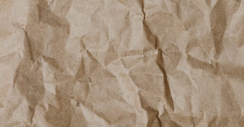 Close-up of crumpled brown paper texture ideal for backgrounds and design projects.